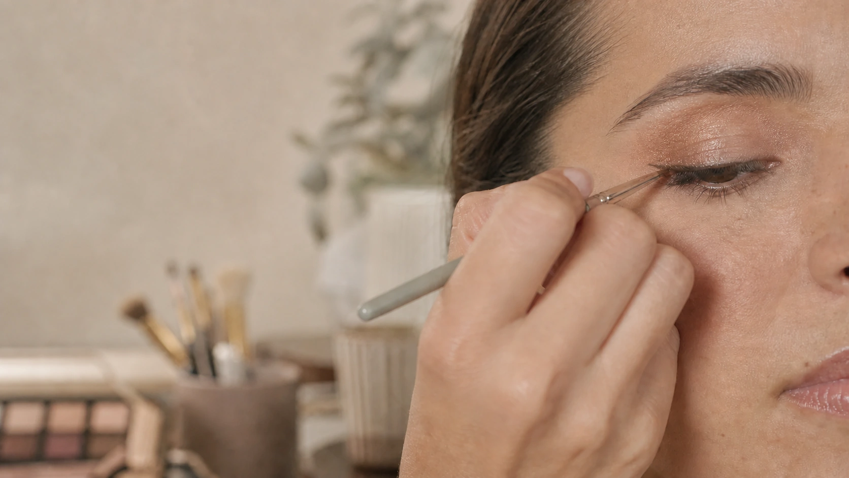 Aplicación precisa de maquillaje en el párpado con un pincel fino
